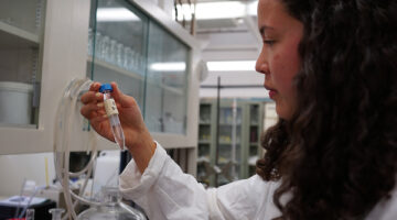 Student studying a sample tube