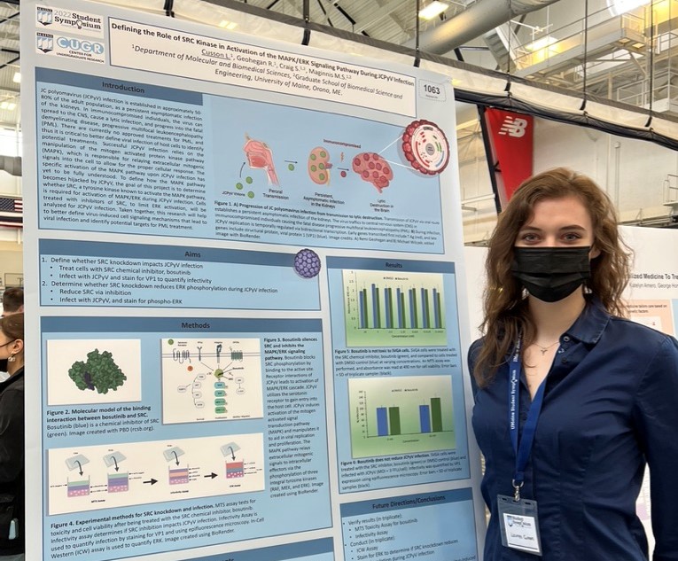 Lauren Cusson, posing next to her poster at the 2022 UMaine Student Symposium